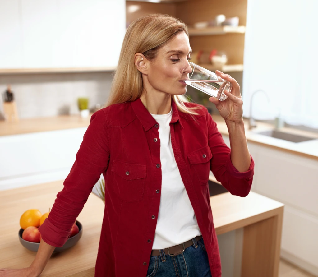 woman drinking water glass